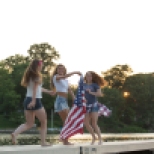Teen girls spinning with US flag